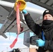 Airman Conducts Weapons Inspection on AIM-9 Sidewinder Missile During Winter Storm