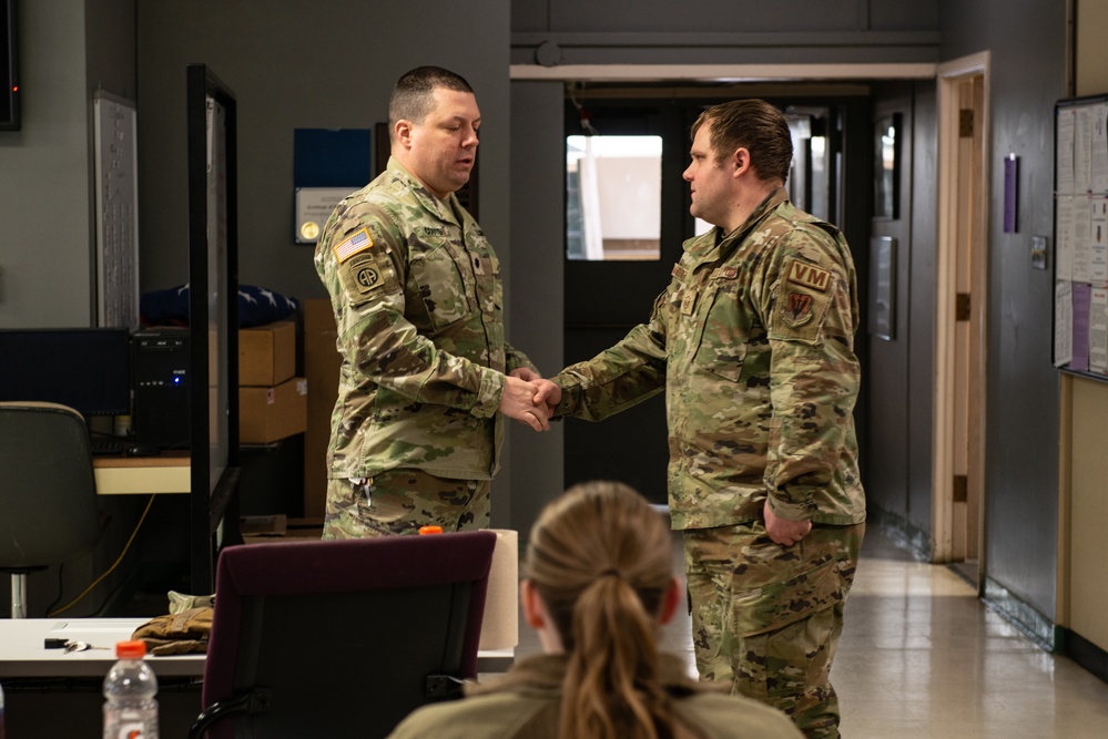U.S. Army officer coins a 107th Attack Wing member for his efforts during the Buffalo winter storm