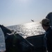 F-16 Fighting Falcon aircraft flies by USS Mason (DDG 87)