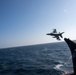 F-16 Fighting Falcon aircraft flies by USS Mason (DDG 87)