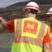 U.S. Army Corps of Engineers Hawai‘i Wildfires Recovery Field Office public affairs chief discusses debris removal truck weigh-in process with USACE Quality Assurance Specialist