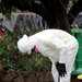 A worker cleans their boots in the contamination reduction zone