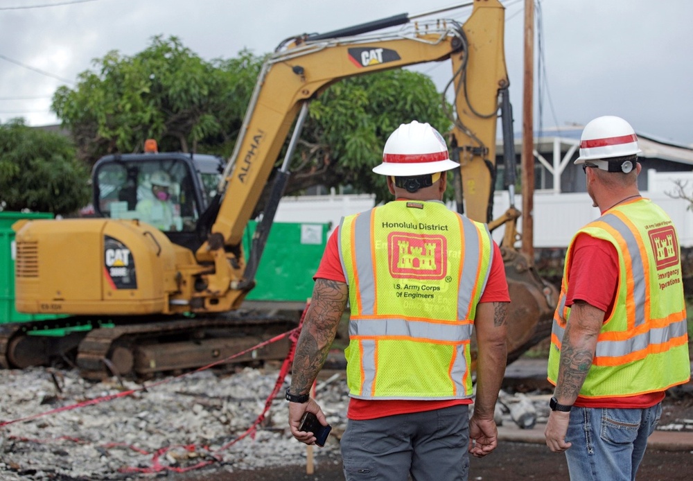 U.S. Army Corps of Engineers quality assurance specialists observe debris removal