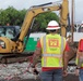 U.S. Army Corps of Engineers quality assurance specialists observe debris removal