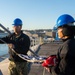 USS Ronald Reagan (CVN 76) Sailors conduct morning colors