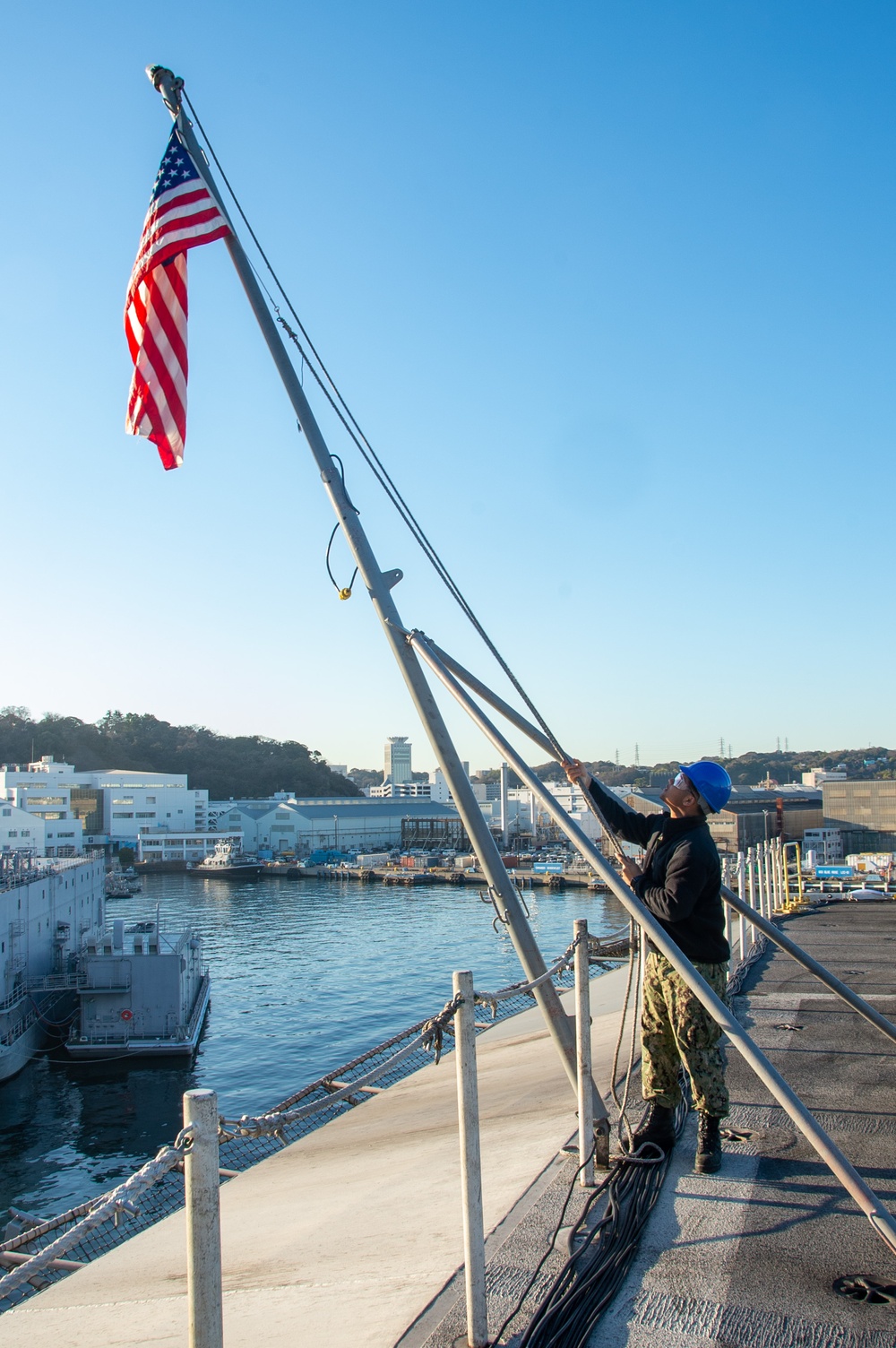 USS Ronald Reagan (CVN 76) Sailors conduct morning colors