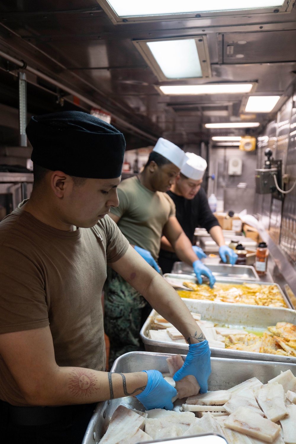 USS Bataan Sailors Cook in Galley