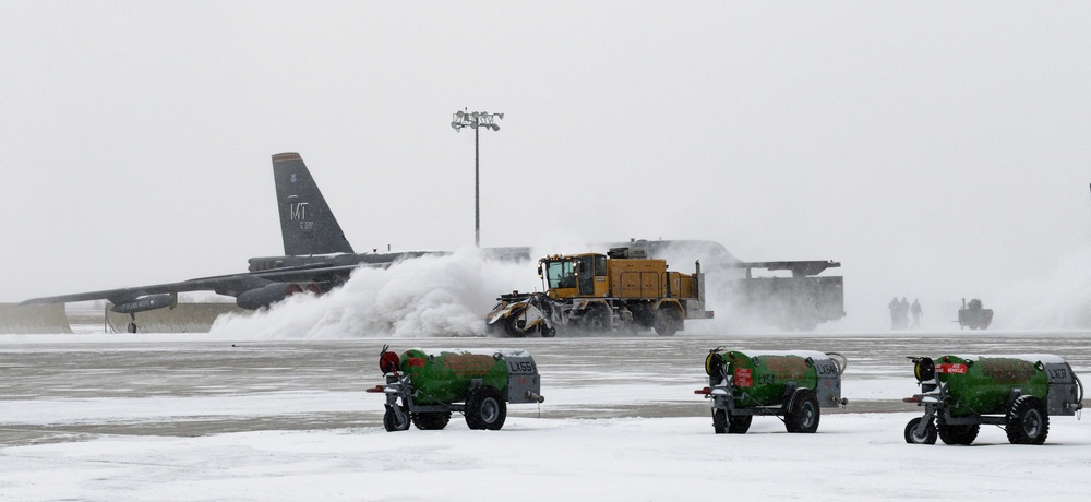 Snowplows clear the flight line at MAFB