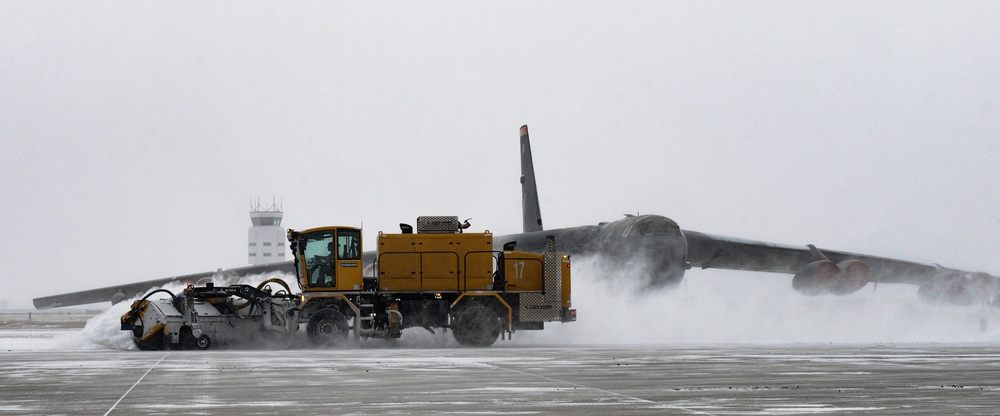 Snowplows clear the flight line at MAFB