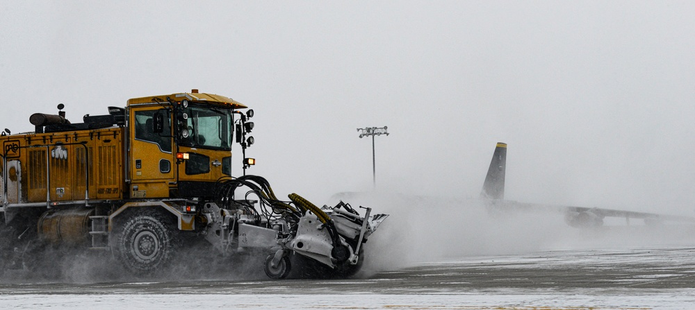 Snowplows clear the flight line at MAFB