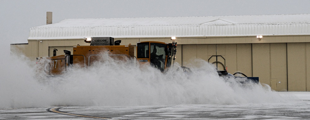 Snowplows clear the flight line at MAFB