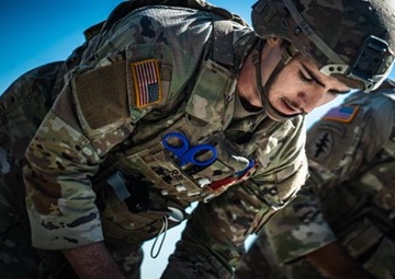 1st Armored Division Soldier administers emergency aid to struck pedestrian