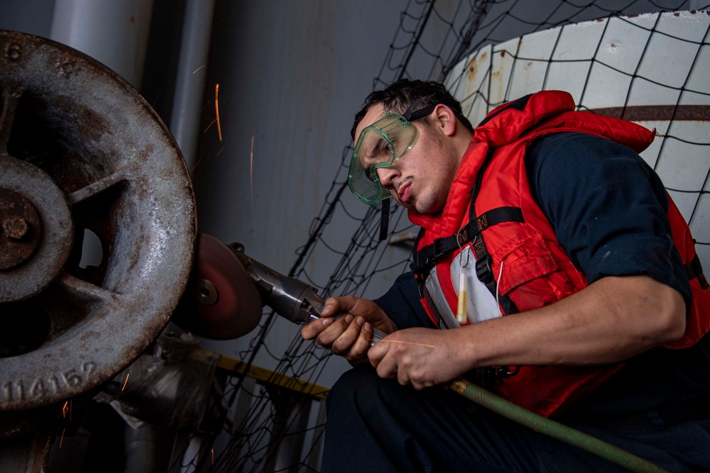 Sailor Removes Rust for Ship Preservation Aboard USS Carl Vinson (CVN 70)