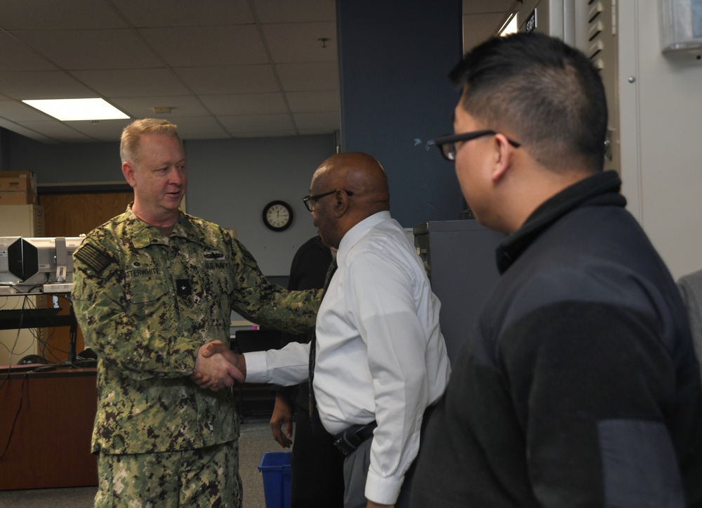 Rear Adm. Stu C. Satterwhite, Commander, MyNavy Career Center (MNCC), speaks with RSC workers during a scheduled visit to SUBASE, Jan. 24, 2023