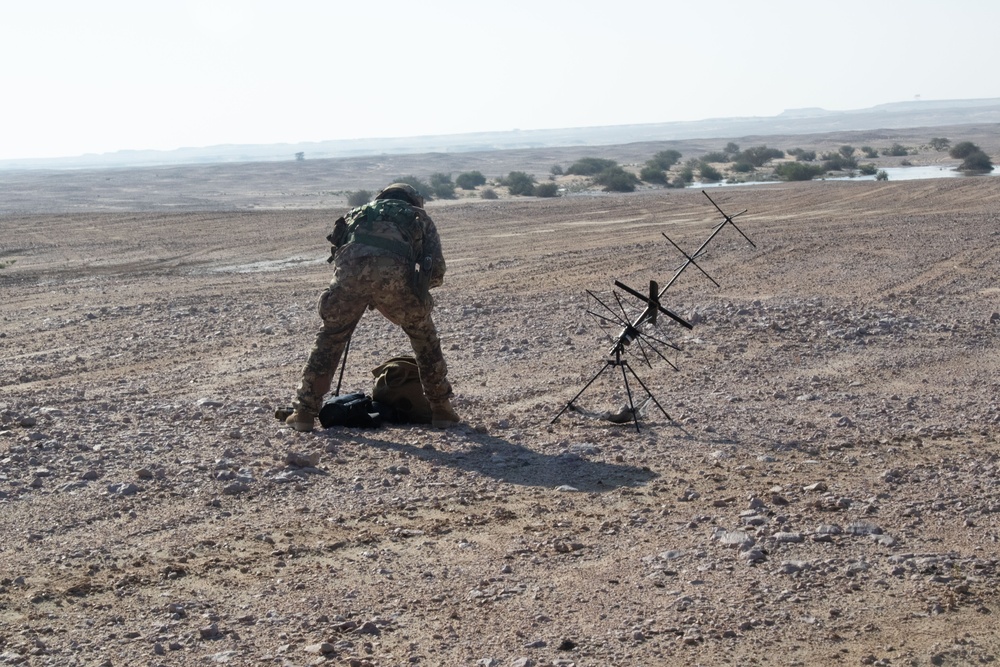 Italian soldiers prepare for a dry fire rehearsal by testing communications equipment during Exercise Ferocious Falcon 5