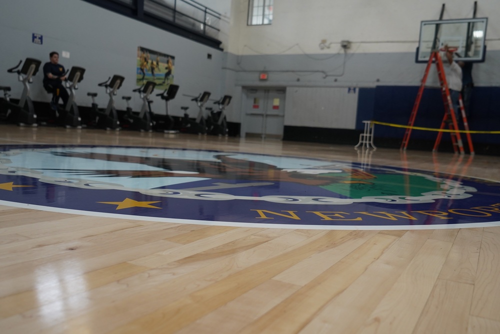 Newly refinished basketball gym floor at Huntington Hall Naval Berthing Facility