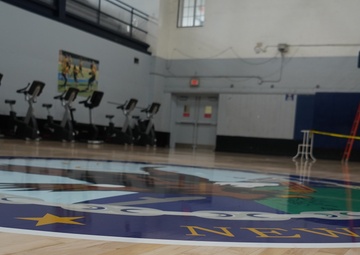 Newly refinished basketball gym floor at Huntington Hall Naval Berthing Facility