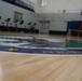 Newly refinished basketball gym floor at Huntington Hall Naval Berthing Facility