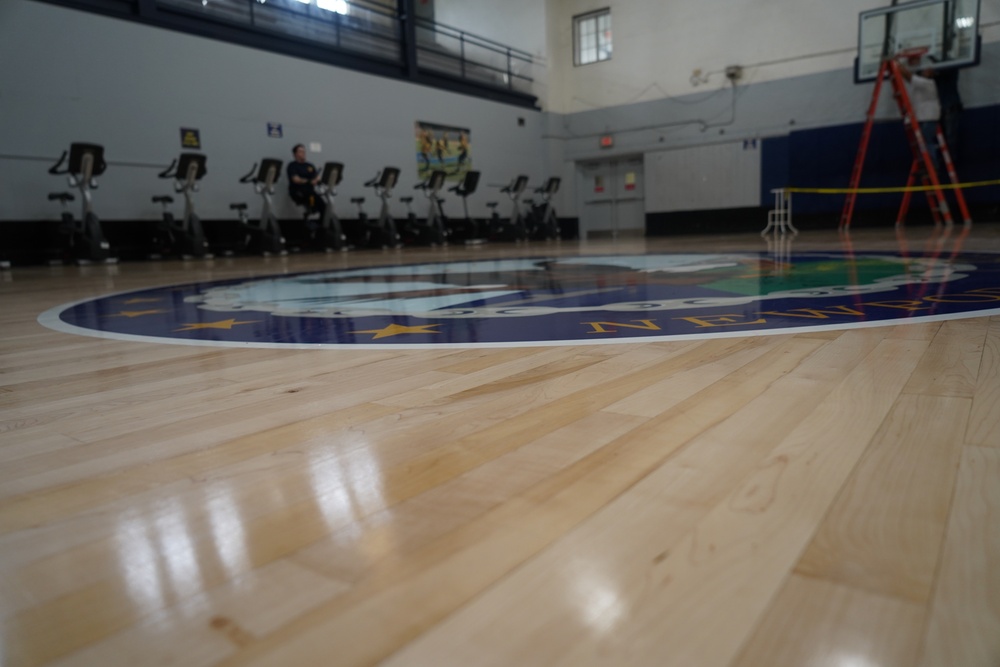 Newly refinished basketball gym floor at Huntington Hall Naval Berthing Facility