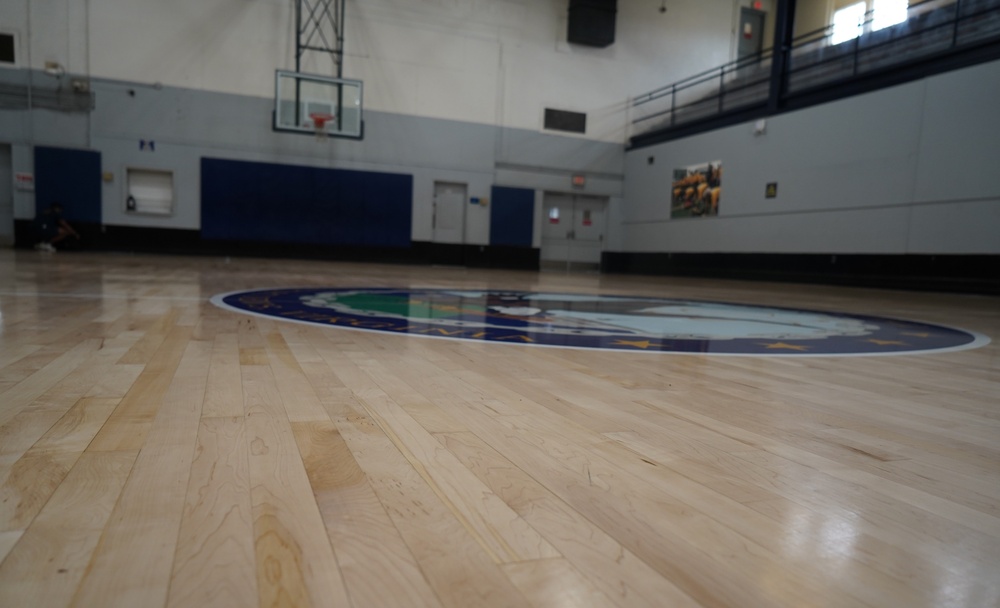 Newly refinished basketball gym floor at Huntington Hall Naval Berthing Facility