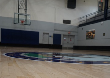 Newly refinished basketball gym floor at Huntington Hall Naval Berthing Facility