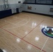 Newly refinished basketball gym floor at Huntington Hall Naval Berthing Facility