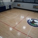 Newly refinished basketball gym floor at Huntington Hall Naval Berthing Facility