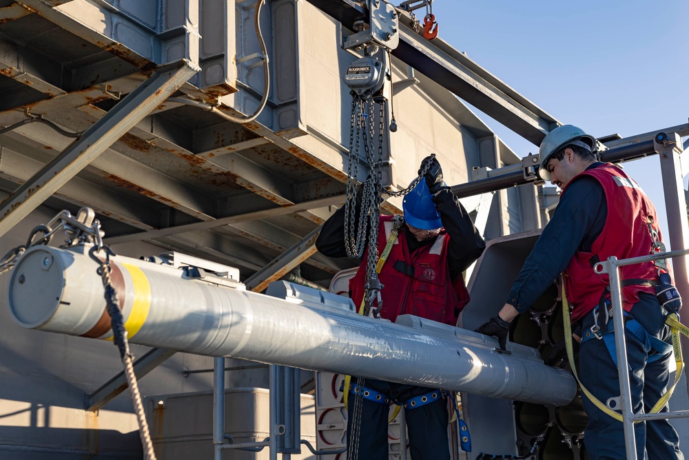 Sailors load a rolling airframe missile launcher