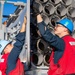 Sailors load a rolling airframe missile launcher