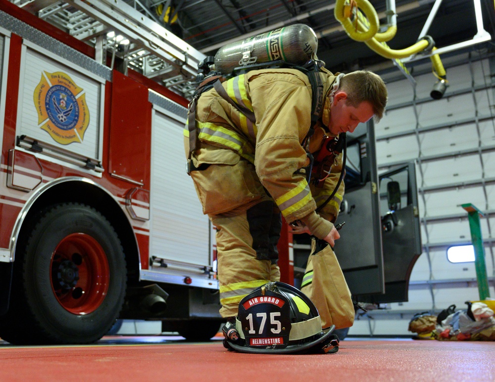 175th CES Firefighter Dons Turnout Gear
