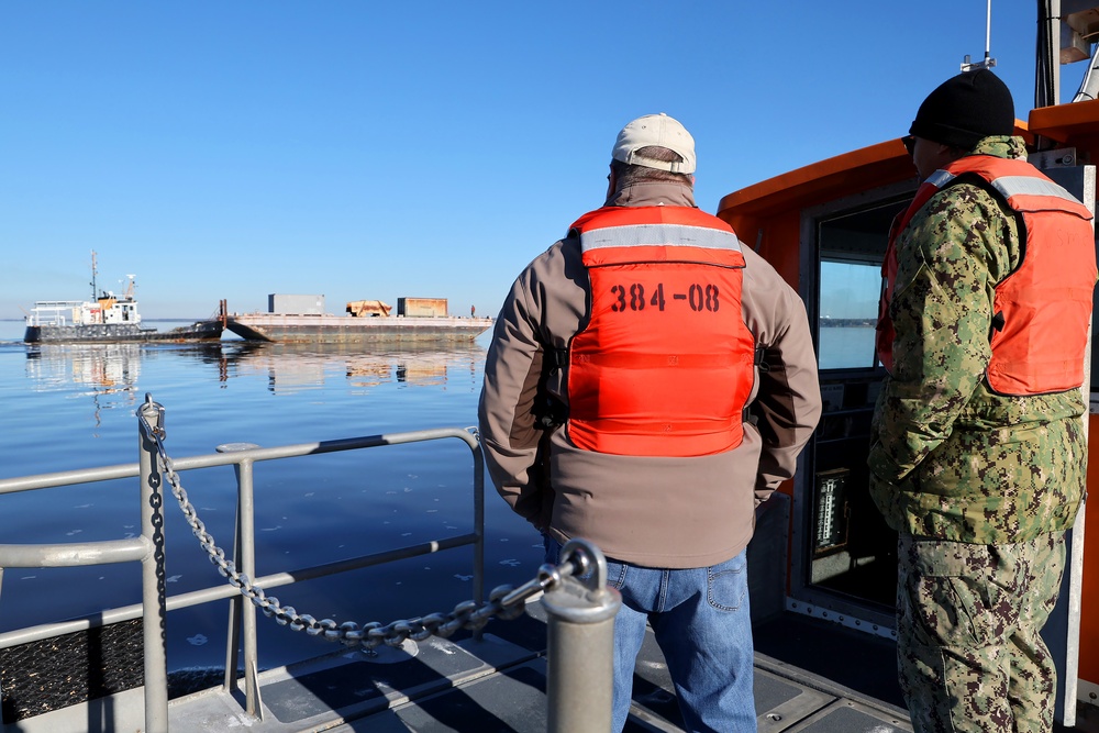 Decommissioned World War II-era fuel barge undergoing a maneuverability test to determine its towing capabilities.