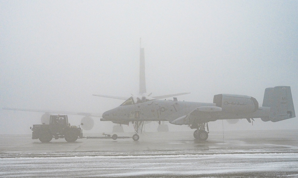 Crews Move Aircraft Across Foggy Airfield at Selfridge Air National Guard Base