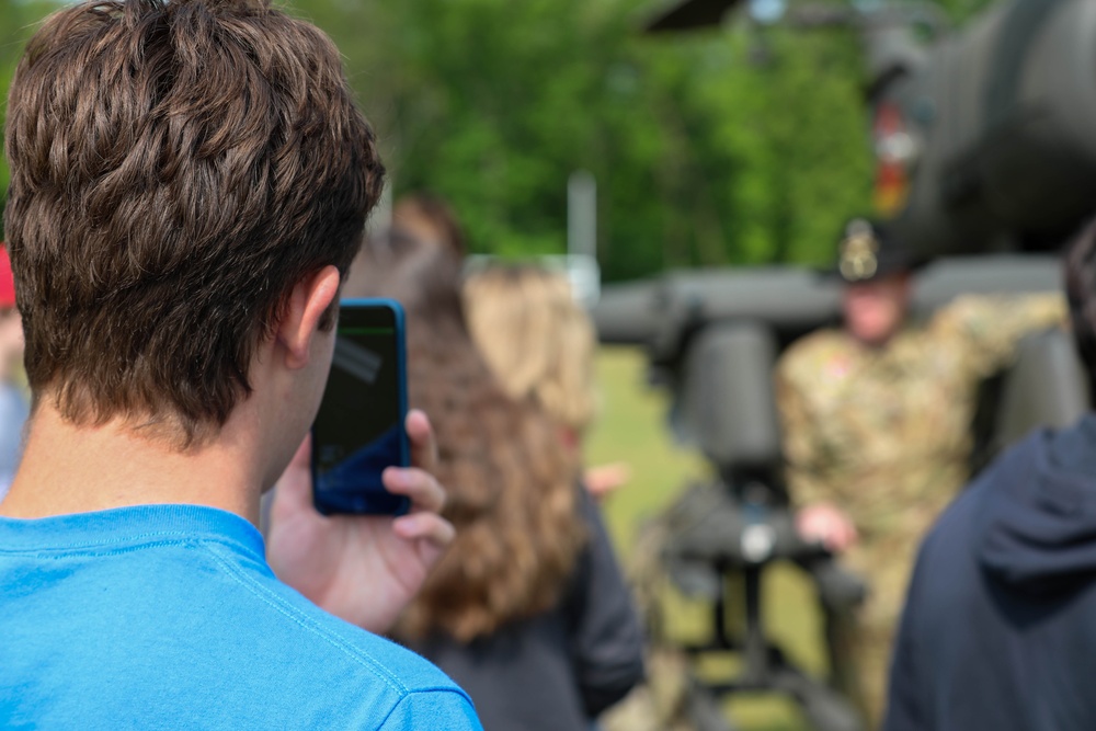 A Student Points His Phone at a Pilot From Fort Drum
