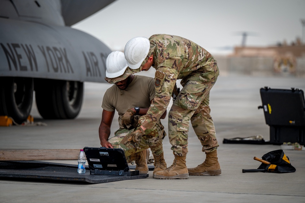Maintenance Airmen repair engine on C-17 Globemaster III