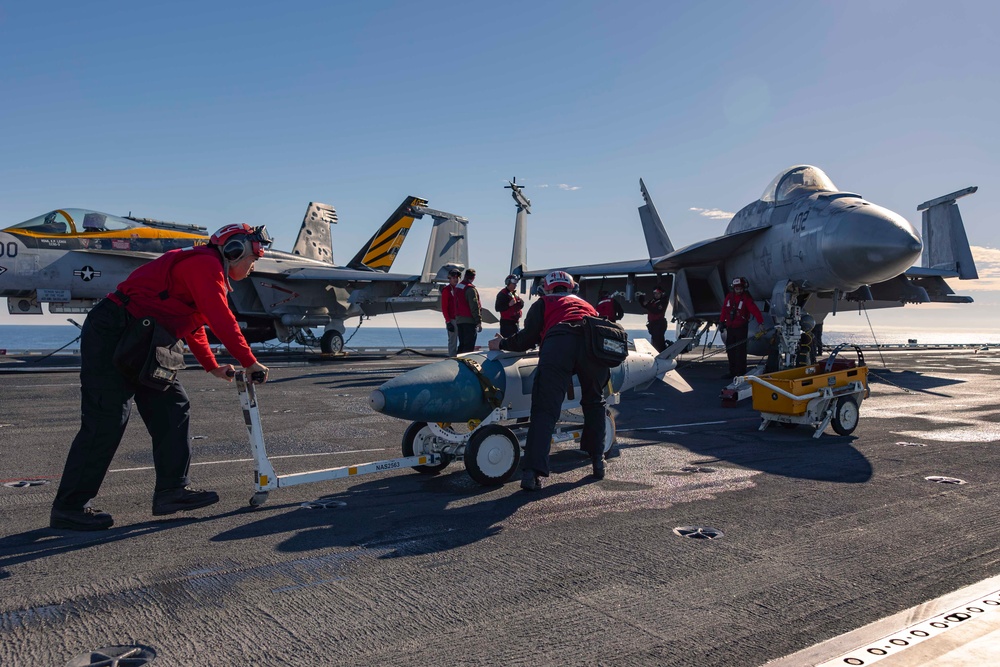 Sailors load ordnance