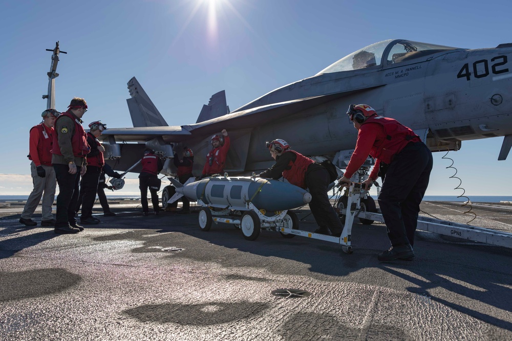 Sailors load ordnance