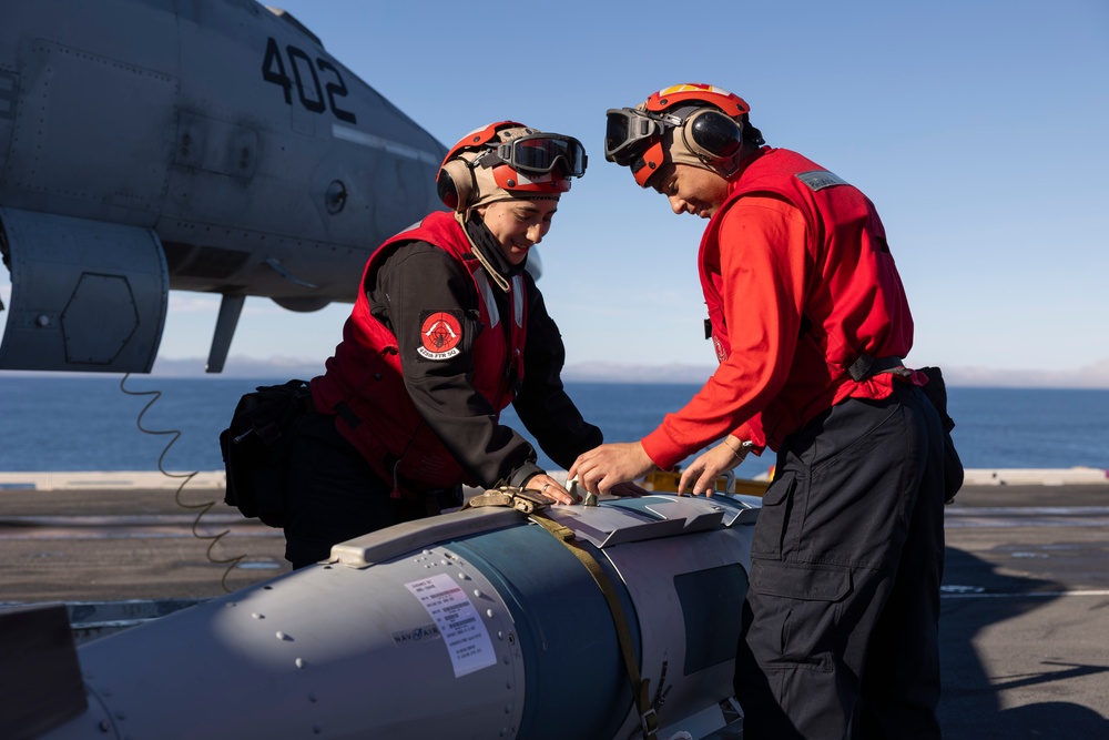 Sailors load ordnance