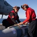 Sailors load ordnance