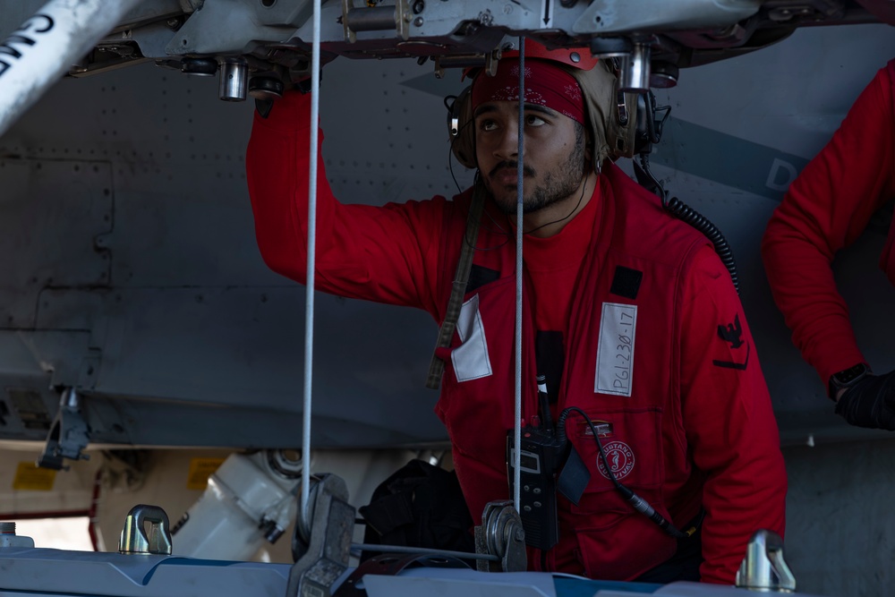 Sailors load ordnance