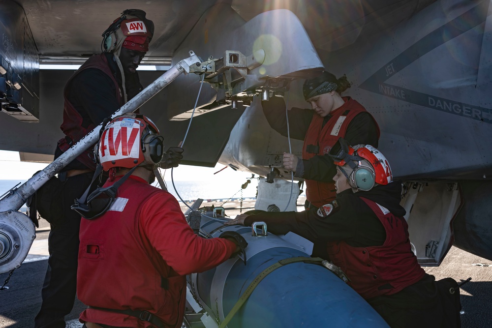 Sailors load ordnance