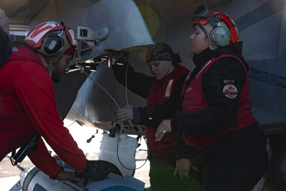 Sailors load ordnance