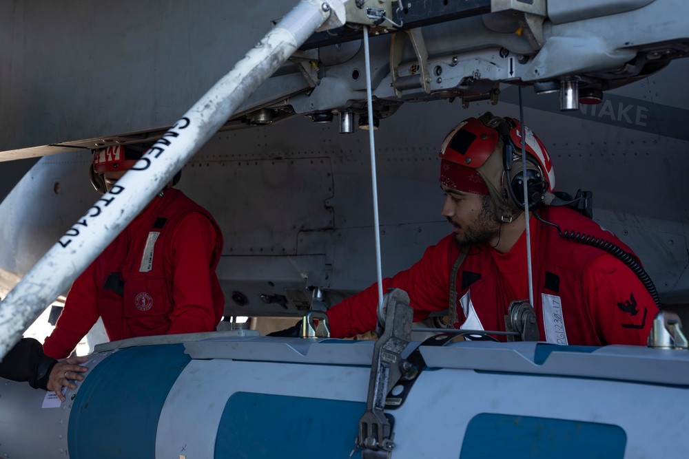 Sailors load ordnance