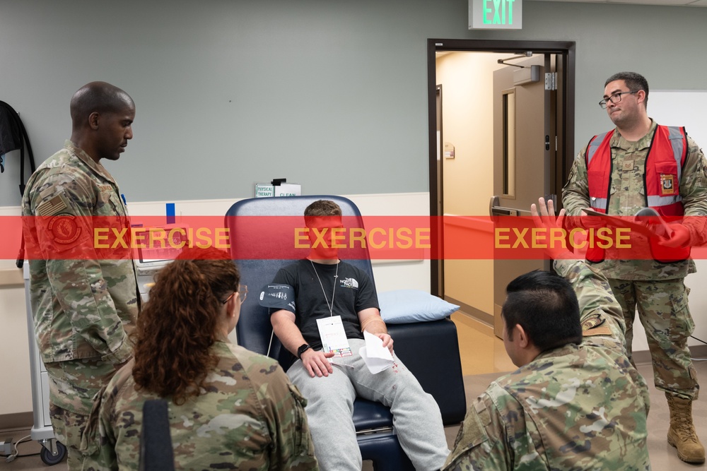 Medical personnel treat a simulated aciident victim.