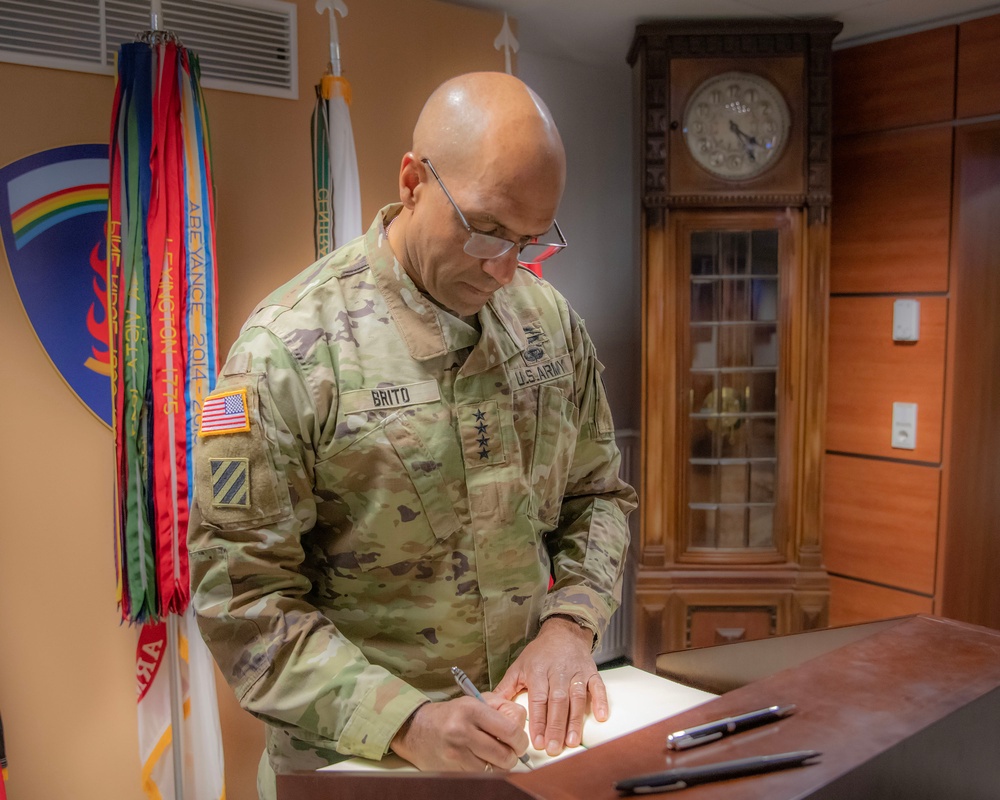 Gen. Gary Brito signs the guest book at the headquarters of U.S. Army Europe and Africa