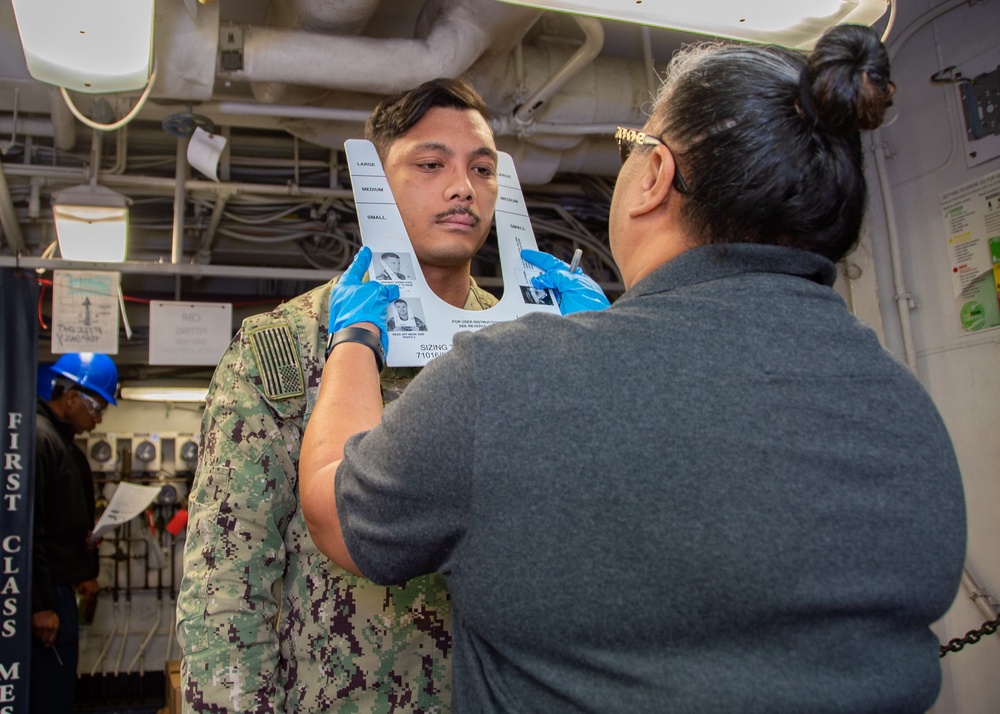 USS Ronald Reagan (CVN 76) conducts Chemical, Biological and Radiological mask and suit fitting