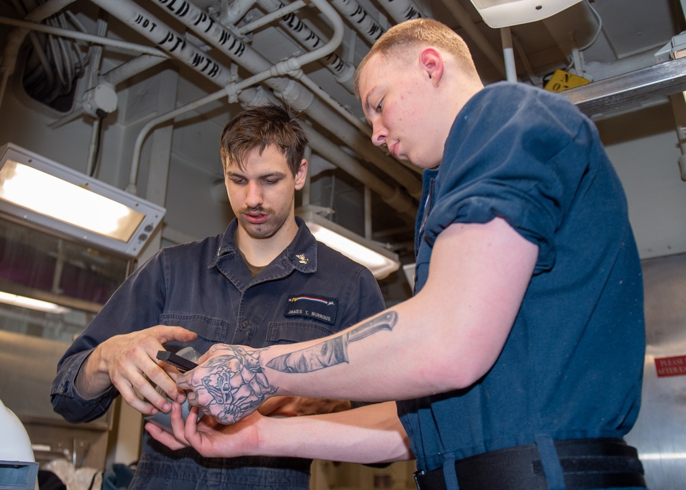 USS Ronald Reagan (CVN 76) Sailors renovate a bathroom