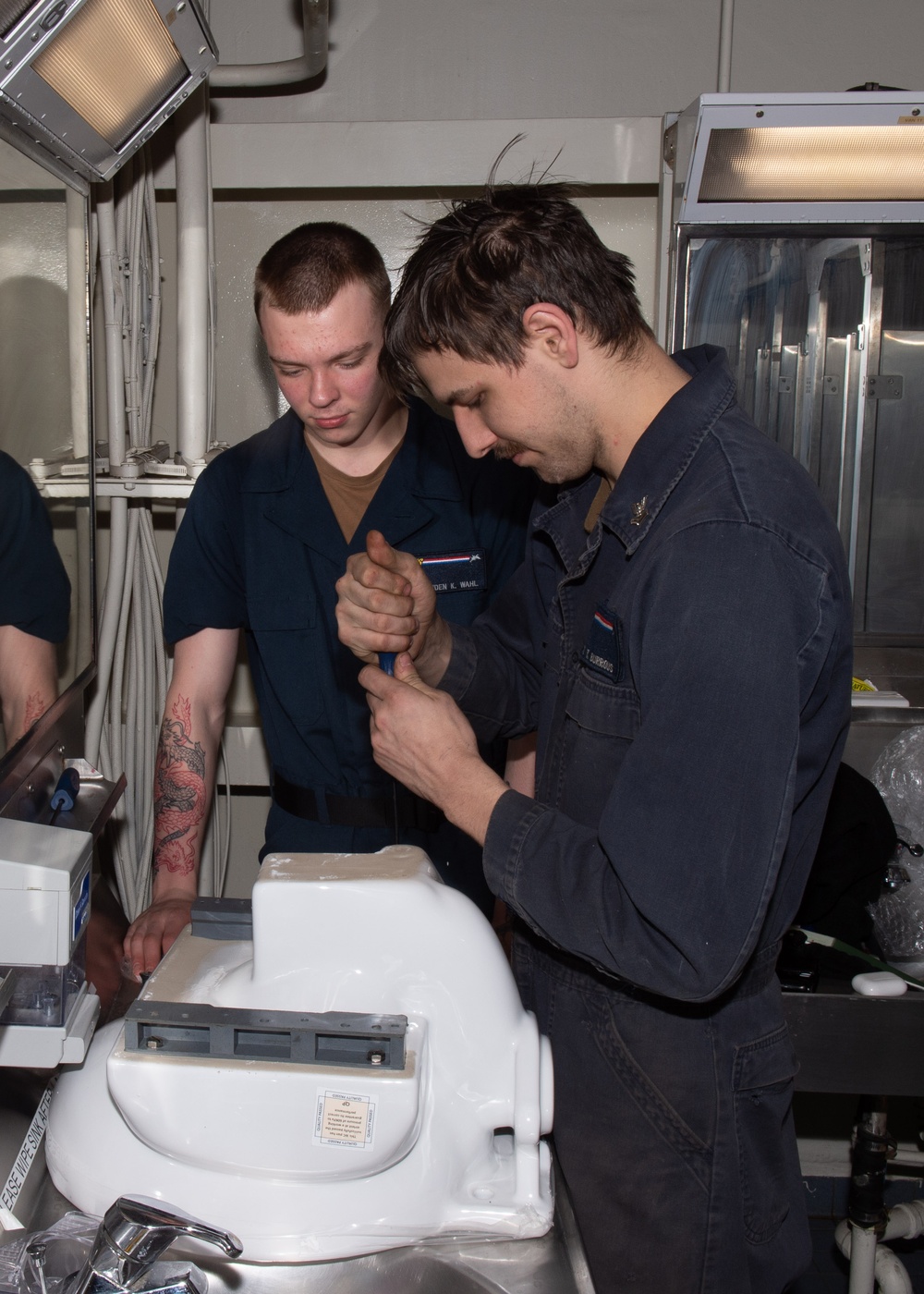 USS Ronald Reagan (CVN 76) Sailors renovate a bathroom