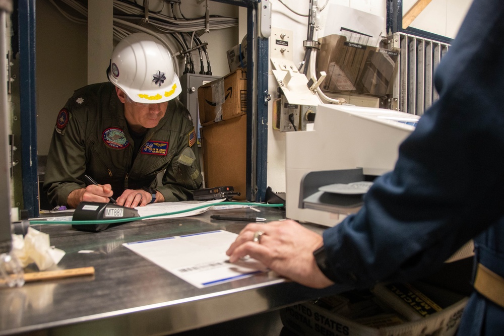 USS Ronald Reagan (CVN 76) Sailors move and process mail