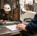 USS Ronald Reagan (CVN 76) Sailors move and process mail