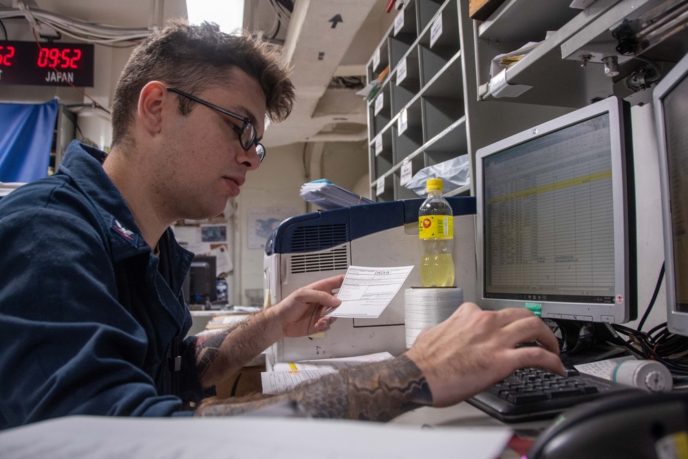 USS Ronald Reagan (CVN 76) Sailors move and process mail